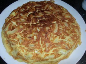 potato onion omelette serve in a large plate 