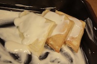 Add a layer of bechamel sauce first and then add crepes 