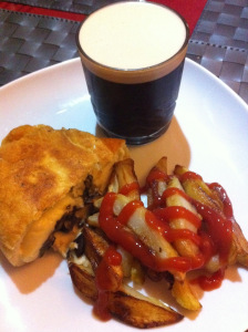folded pizza and chips served with Guinness 